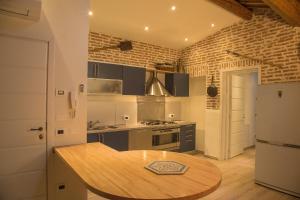 a kitchen with a wooden table in a room at Agriturismo Ferrara Chalet in Vigarano Mainarda