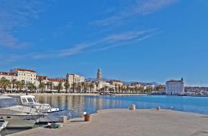 a marina with boats in the water and a city at Apartments Emi in Split