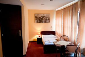 a hotel room with a bed and a table and a desk at Botel Gracia in Bratislava +37 photos