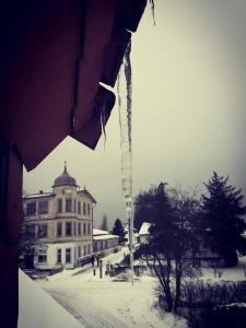 ein Eiszapfen, der von der Seite eines Gebäudes im Schnee hängt in der Unterkunft Gästehaus & Restaurant Seemannshus (Pension) in Vitte