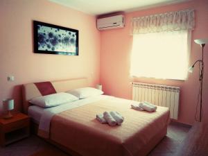 1 dormitorio con 1 cama con 2 toallas en ApartHotel Viola en Pula