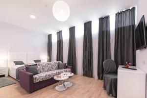 a living room with a couch and a table at PRIMA Life Spalato in Split