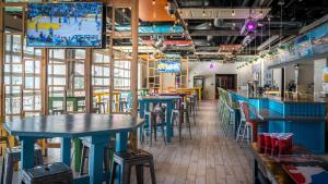 a bar with blue tables and stools in a restaurant at OYO Hotel and Casino Las Vegas in Las Vegas