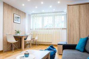 a living room with a couch and a table at Villa Vitalis in Muszyna