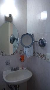 a bathroom with a sink and a mirror at Residencial Gran Santa Fe Cancun in Cancún