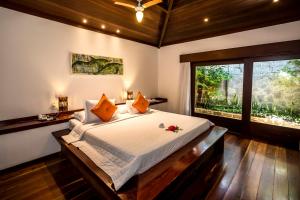 a bedroom with a bed and a large window at Sombra e Água Fresca Resort in Pipa +77 photos