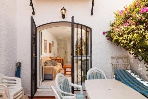 an open door to a room with tables and chairs at Los Pinos 23 Villas Casasol in Nerja
