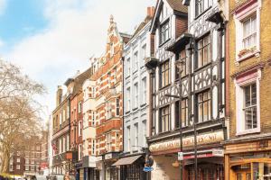 a row of buildings on a city street at Be London - The Soho Residences in London