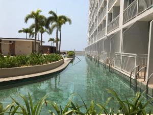arial view of a canal in a building with palm trees at Manila Bay Breeze Residences near MOA and NAIA in Manila