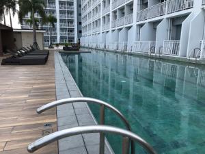 a swimming pool in the middle of a building at Manila Bay Breeze Residences near MOA and NAIA in Manila
