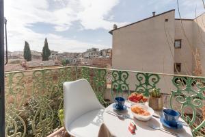 a table with a bowl of fruit on a balcony at Sleep Tight Florence Apartment in Florence