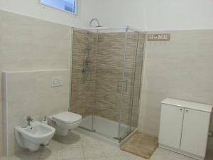 a bathroom with a shower and a toilet and a sink at Casa Bruna in Verbania