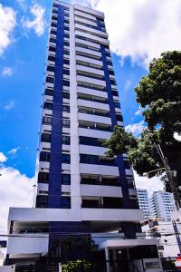 un edificio alto azul y blanco en una ciudad en Apartamento - Ed Jatiuca, en Recife