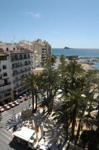 a view of a city with palm trees and the ocean at Hotel Tanit in Benidorm
