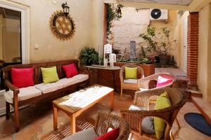 a living room with a couch and chairs and a clock at Charming Hôtel - Les Pasteliers in Albi +93 photos