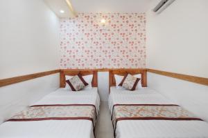 Nhat Minh Anh Hotel tesisinde bir odada yatak veya yataklar