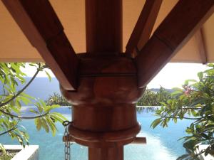 a view of the pool from the porch of a resort at The Puncak Lombok in Senggigi