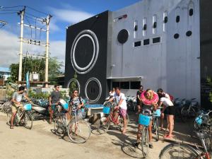 a group of people on bikes in front of a ship at Song of Travel Hostel in Nyaungshwe Township