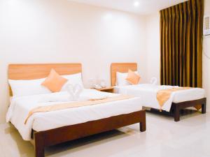 Postel nebo postele na pokoji v ubytování Rublin Hotel Cebu
