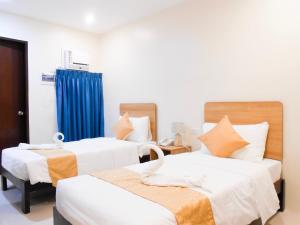 Postel nebo postele na pokoji v ubytování Rublin Hotel Cebu