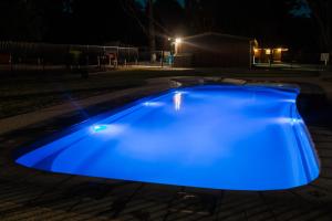 a blue swimming pool lit up at night at Eildon Pondage Holiday Park in Eildon