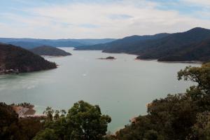 a view of a large body of water with mountains at Eildon Pondage Holiday Park in Eildon