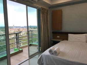 Postel nebo postele na pokoji v ubytování AP Grand Residence