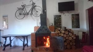 a fireplace with a bike hanging on a wall at La Casa de la Montaña in Cortes de Arenoso