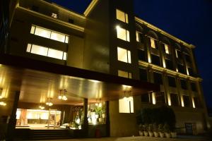 a large building with lights on at night at Lemon Tree Hotel Siliguri in Siliguri