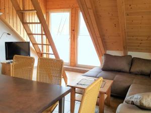 a living room with a couch and a table at Urlaubsreif-Rügen in Glowe