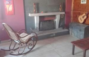 a living room with a chair and a fireplace at La Corte di Nonno in Frascati