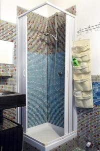 a bathroom with a shower with a glass door at Solsicily in Catania