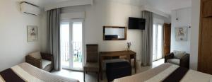 a hotel room with two beds and a mirror at Hostal Enriqueta in Marbella