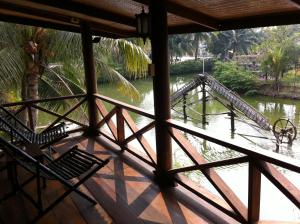 a view of a bridge over a river from a porch at Baan Thai House in Phra Nakhon Si Ayutthaya