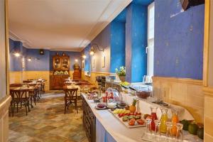 a large kitchen with blue walls and tables and chairs at Hotel Atalaya- FREE PARKING GRATUITO in Mundaka