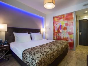 a bedroom with a large bed and a large window at TWO Hotel Berlin by Axel - Adults Only in Berlin