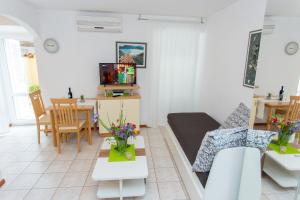 een woonkamer met een bank en een tafel bij Apartments Villa Sol in Ston
