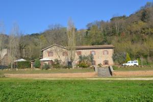 a large brick house with a truck parked in front of it at Agriturismo Le Forre del Treja in Civita Castellana