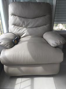 a white leather recliner with two pillows on it at First line Apartment in Alicante