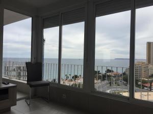 a room with a window with a view of the ocean at First line Apartment in Alicante