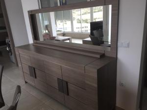 a large mirror on a dresser in a living room at First line Apartment in Alicante