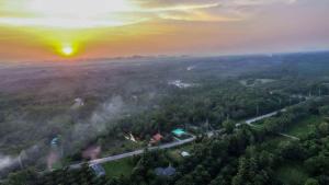 an aerial view of a foggy forest with a sunset at Bar Horizon Hostel in Chumphon