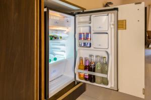 an open refrigerator filled with lots of drinks at Rendezvous Beach Resort Panjim in Dona Paula