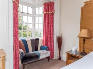 a living room filled with furniture and a window at Lyzzick Hall Hotel in Keswick