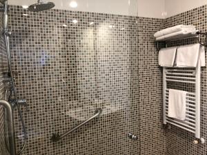 a bathroom with a shower with a glass door at El Colorín in Los Molinos