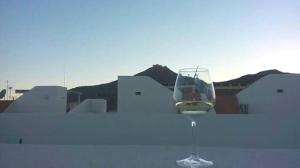 a glass of wine sitting on top of a table at Casa Nettuno Favignana in Favignana