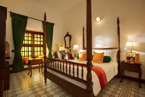מיטה או מיטות בחדר ב-Forte Kochi