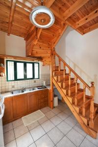 a kitchen with a wooden ceiling and a staircase at Pieros Studios Lisipios in Paleokastritsa