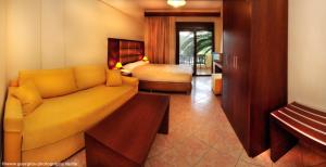 a living room with a couch and a bedroom at Vergos Hotel in Vourvourou +37 photos