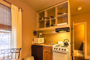 a kitchen with a white stove and a microwave at Snow Goose Bed and Breakfast in Keene Valley